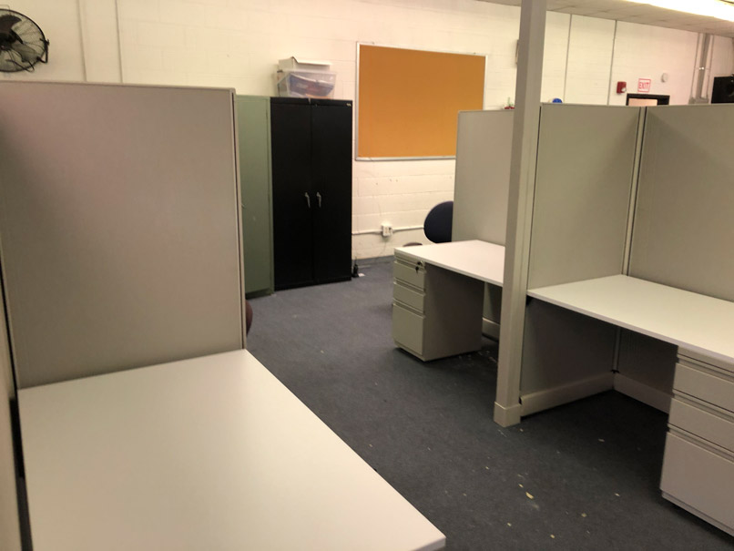 three cubicles and filing cabinets